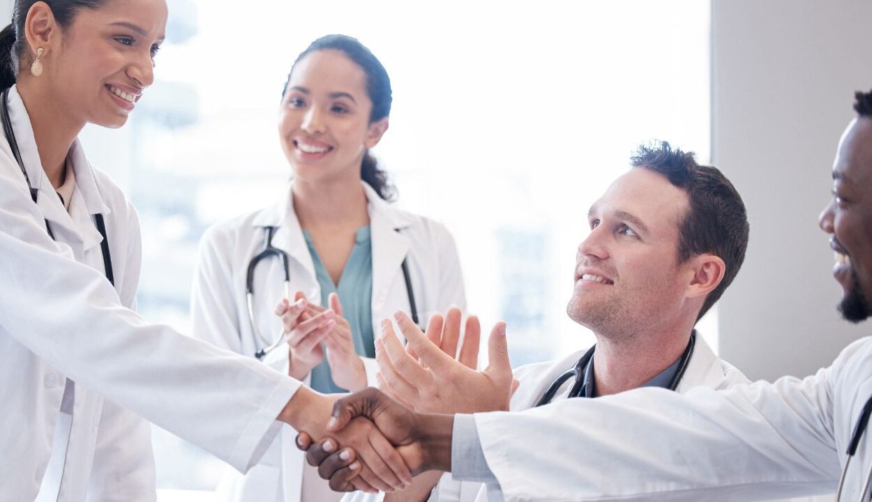 doctors greeting a new colleague to the team