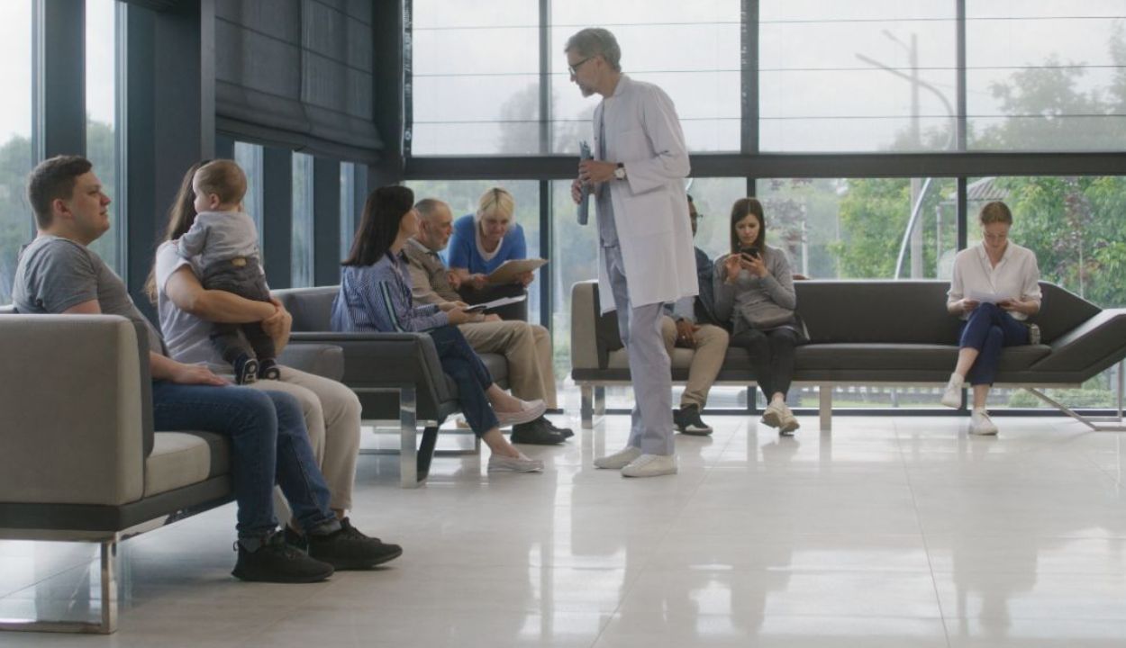 physician in a clinic lobby with patients