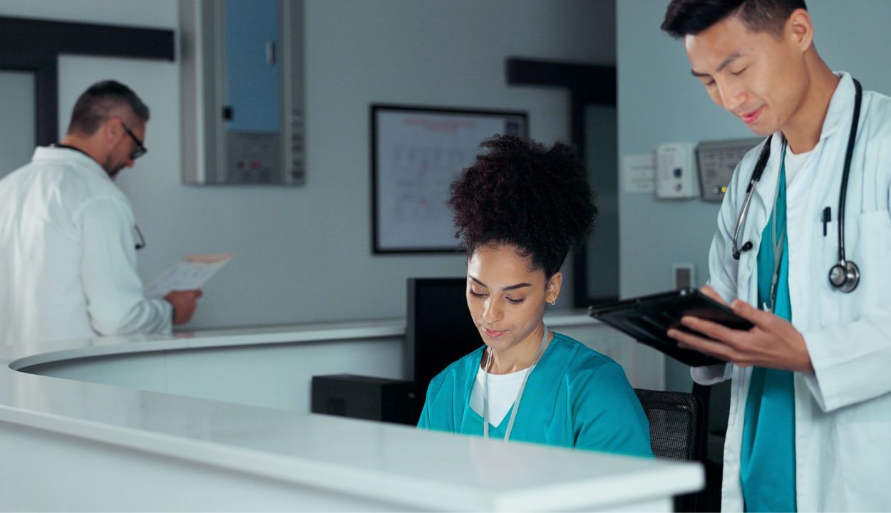 physician looking over front counter paperwork