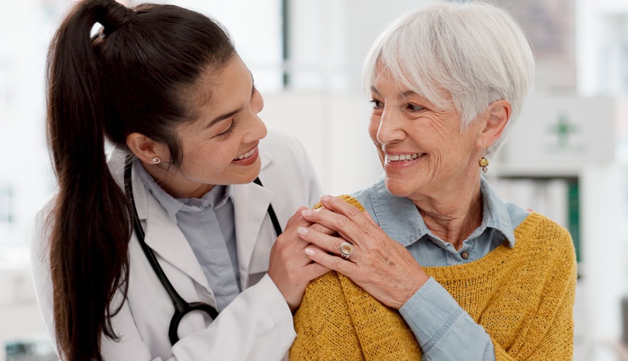 doctor touching shoulder of older patient