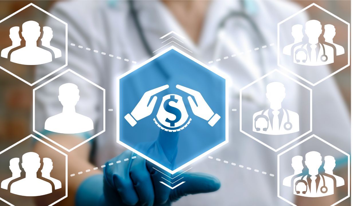 physician pointing to digital graphics of icons with dollar sign