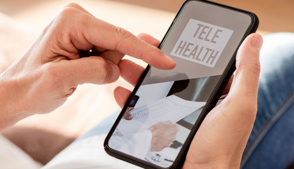 person using a cell phone to dial into telehealth meeting