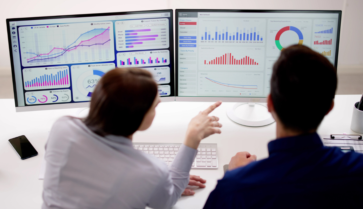 healthcare executive examining performance charts on computers